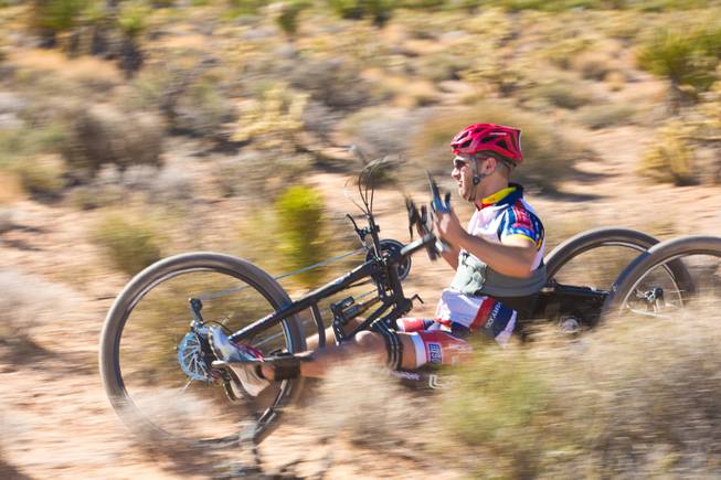 26 year-old Nathan DeWalt, Navy Veteran, navigates through Blue Diamond on a 3-wheel hand-powered mountain bike, built by Bill Lasher of Las Vegas, during the Ride 2 Recovery Las Vegas Mountain Bike Challenge Monday, Jan. 27, 2014. DeWalt, who was paralyzed from the waist down after motorcycle crash in 2008, is among many wounded veterans who are being helped by Ride 2 Recovery, a nonprofit organization that provides rehabilitation to injured veterans through cycling.
